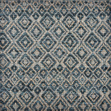 Handwoven rug sample in a radiating diamond pattern in shades of teal blue, grey, and tan. 