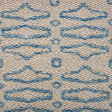 Handowoven rug sample with an abstract geometric linear design in marine blue on a cream field. 