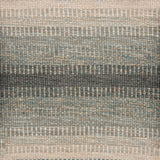 Handwoven rug sample in a subtle striped ombré pattern ranging from beige to sea green. 