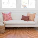 A bright living space with a large cowhide rug in tan with a geometric stripe overlay in cream.