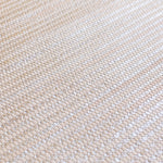 Detail of woven upholstery leather in a grid pattern in metallic tan.