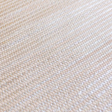 Detail of woven upholstery leather in a grid pattern in metallic tan.