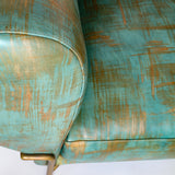 Close-up of a modernist armchair upholstered in leather in a textural brushstroke pattern in turquoise and gold.