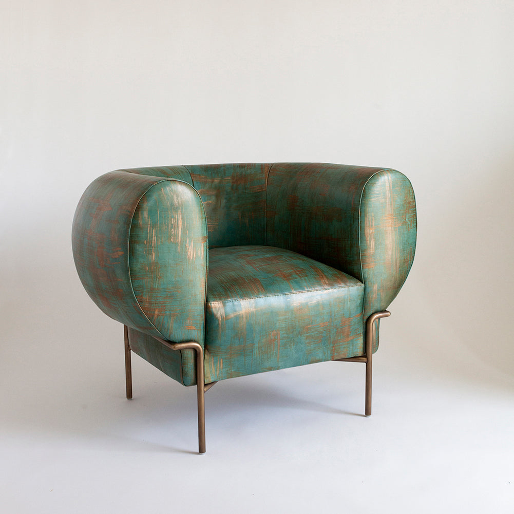 A curvilinear modernist armchair upholstered in leather in a textural brushstroke pattern in turquoise and gold.