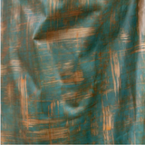 Detail of upholstery leather in a textural brushstroke pattern in turquoise and gold.