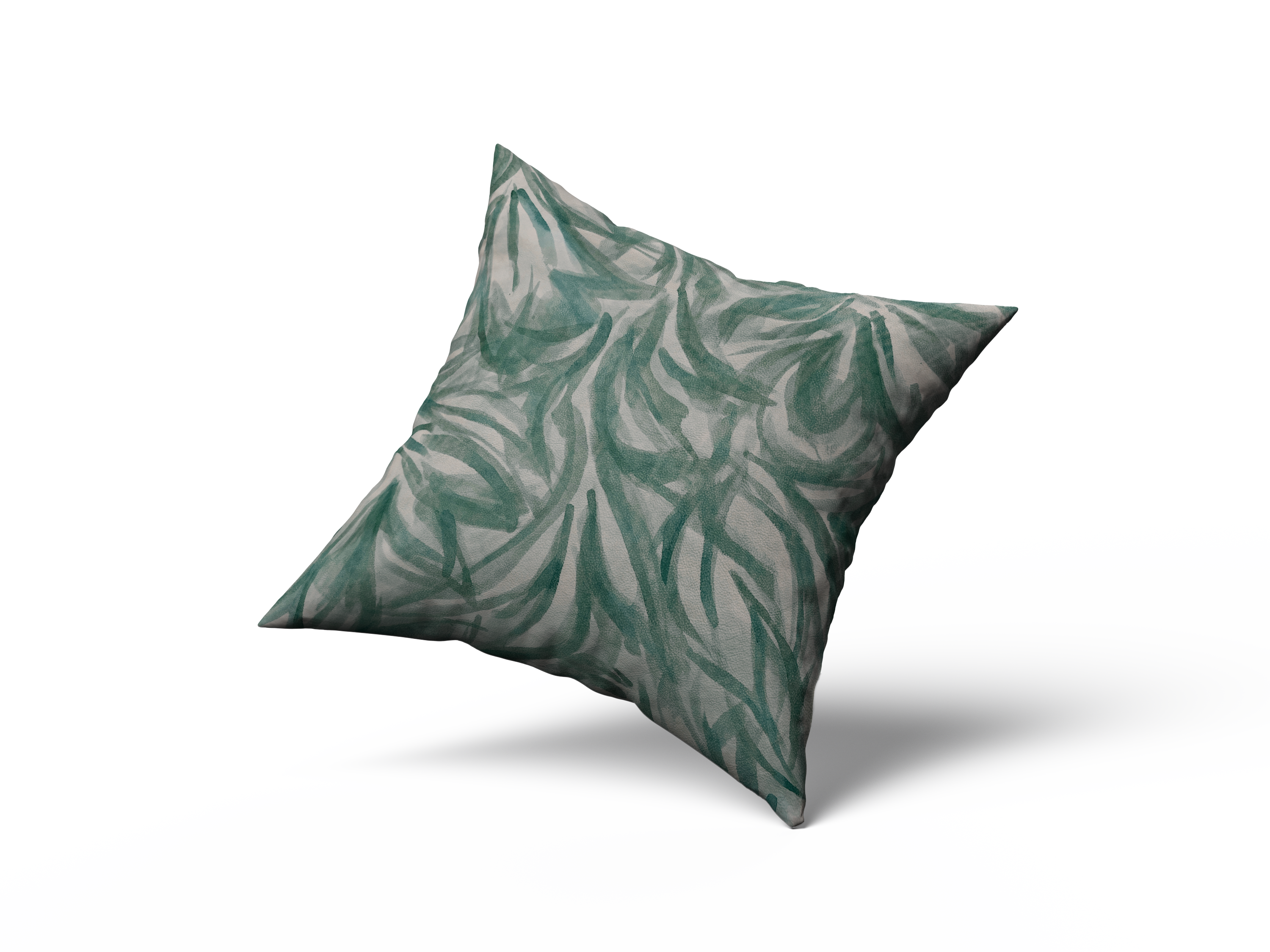 A throw pillow upholstered in cream leather with a painterly botanical overlay in green and gray.