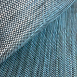 Close-up of draped upholstery leather in a tight woven texture in shades of blue.