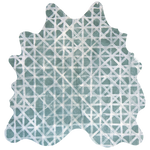 Detail of a cowhide rug in sage with a white lattice overlay.