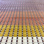 Close-up of a leather rug in a woven stripe pattern in shades of purple, black, coral and yellow.