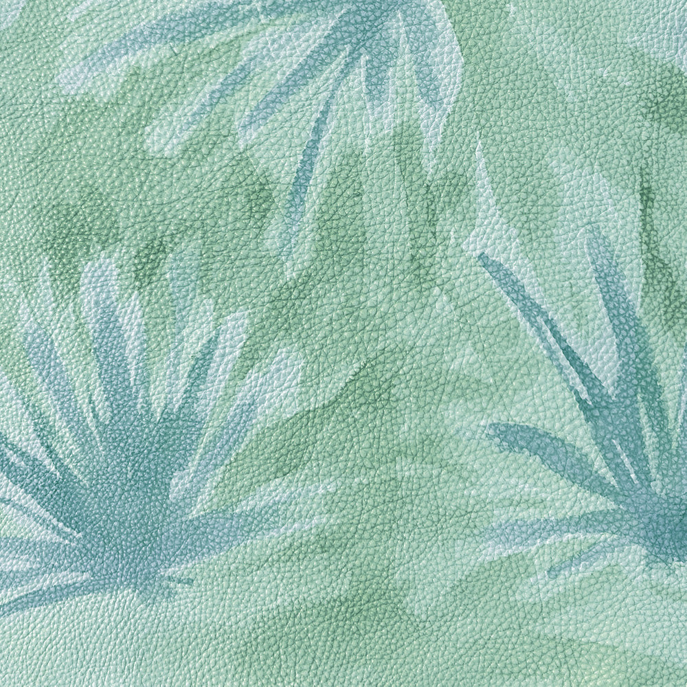 Close-up of a cowhide rug in green with a painterly flower print in shades of blue.