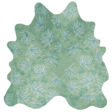 Detail of a cowhide rug in green with a painterly flower print in shades of blue.