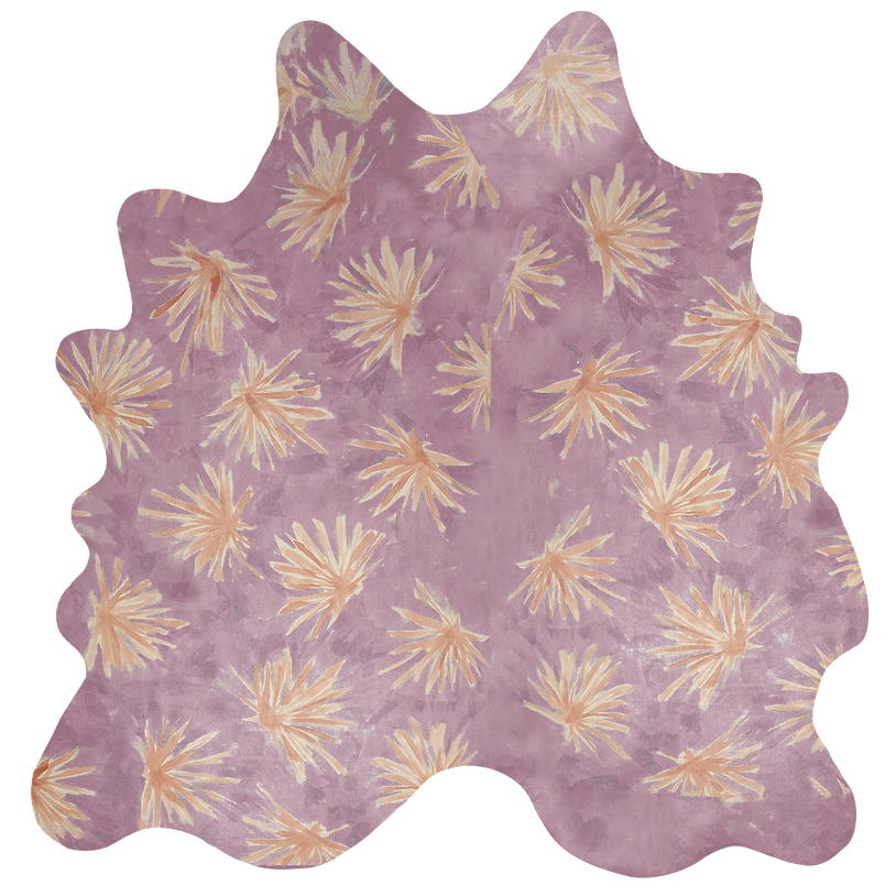 Detail of a cowhide rug in purple with a painterly flower print in yellow and orange.