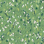Detail of wallpaper in a painterly leaf print in shades of green and white on a kelly green field.