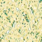 Detail of wallpaper in a painterly leaf print in shades of green and white on a yellow field.