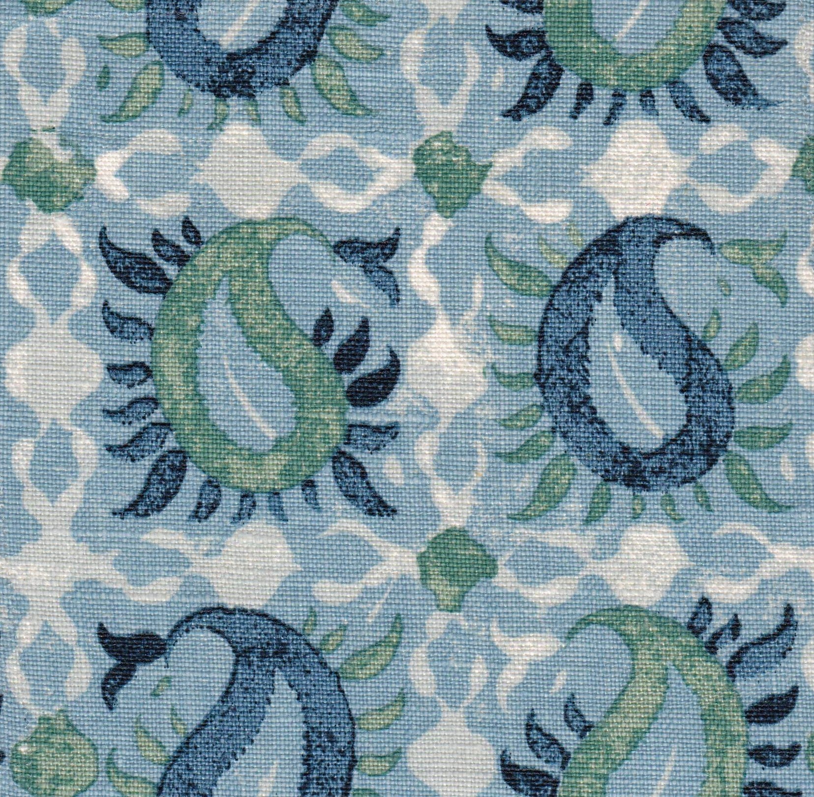 Detail of fabric in a paisley print in shades of blue, green and navy on a white field.