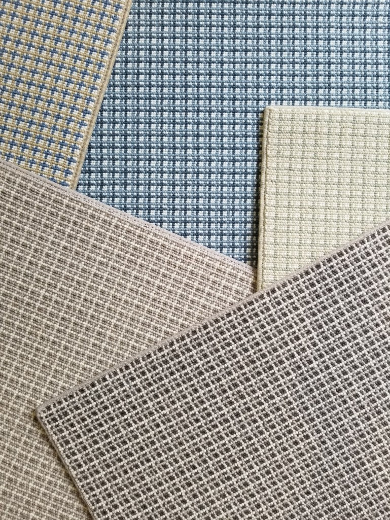 Collection of plaid broadloom swatches in various colors