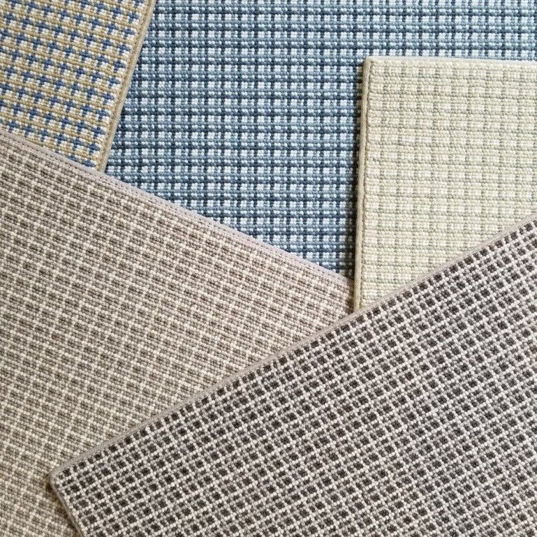 Collection of plaid broadloom swatches in various colors