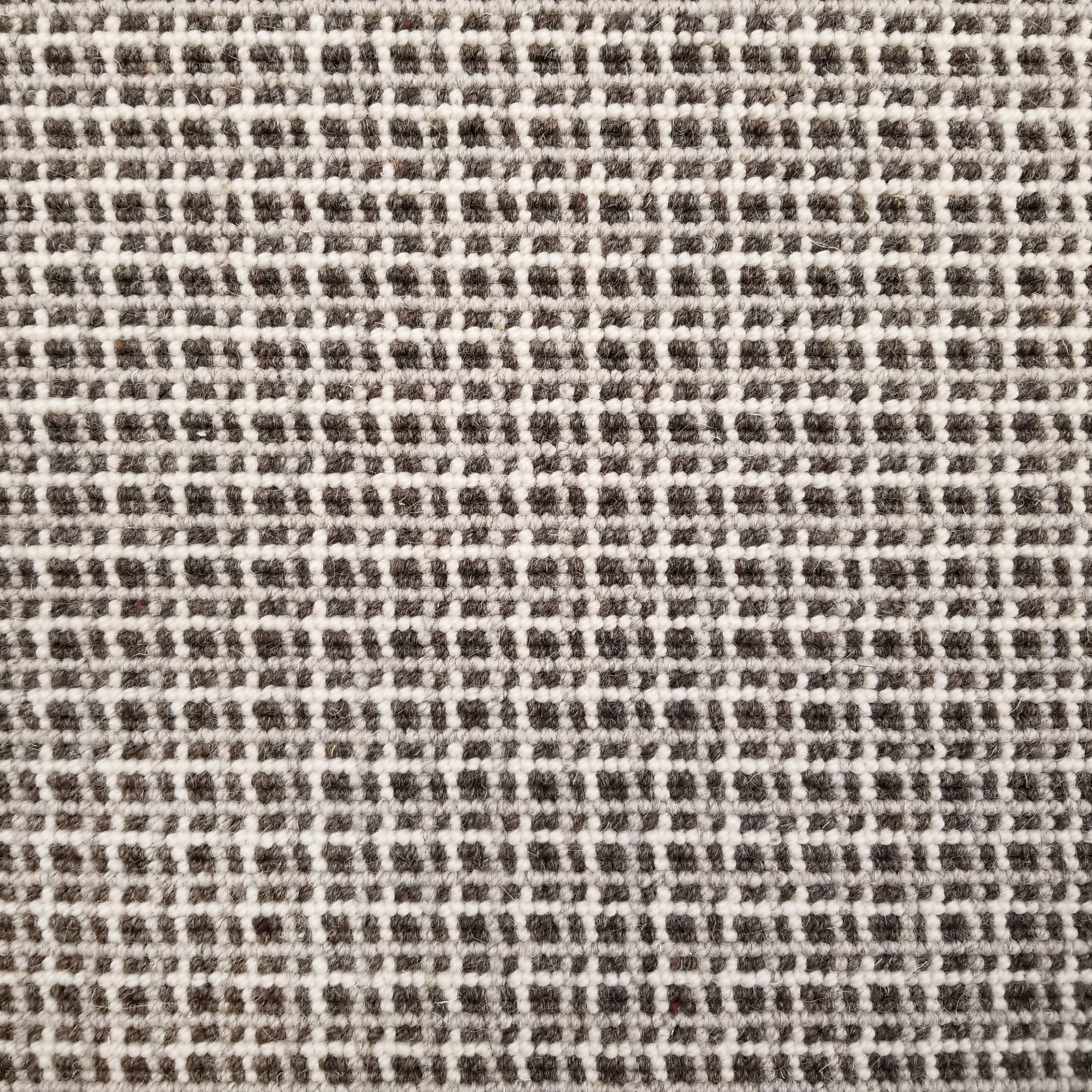 Broadloom carpet with plaid design in brown and cream.