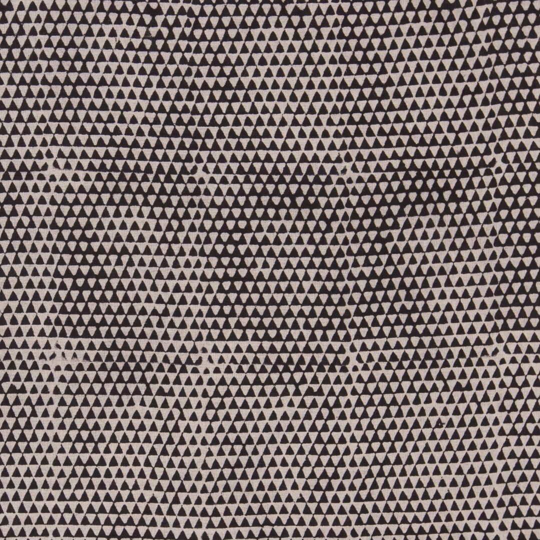 Detail of fabric in a small-scale triangle print in black on a tan field.