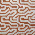 Detail of wallpaper in a playful meandering print in white on a sienna field.