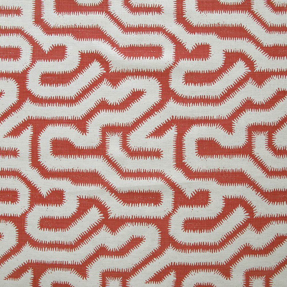 Detail of fabric in a playful meandering print in white on a coral field.