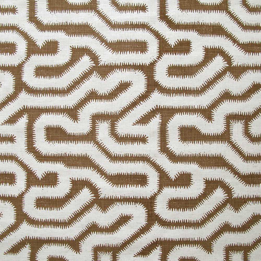 Detail of fabric in a playful meandering print in white on a brown field.