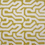 Detail of wallpaper in a playful meandering print in white on a mustard field.