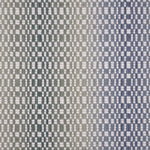 Broadloom carpet with a white checkerboard pattern with an ombré effect in blue and green. 