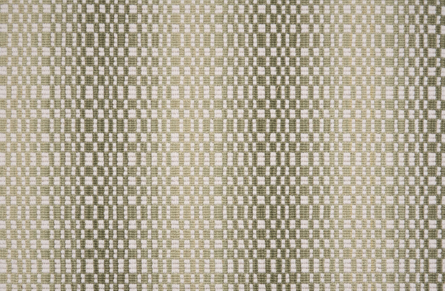 Broadloom carpet with a white checkerboard pattern with an ombré effect in shades of green.