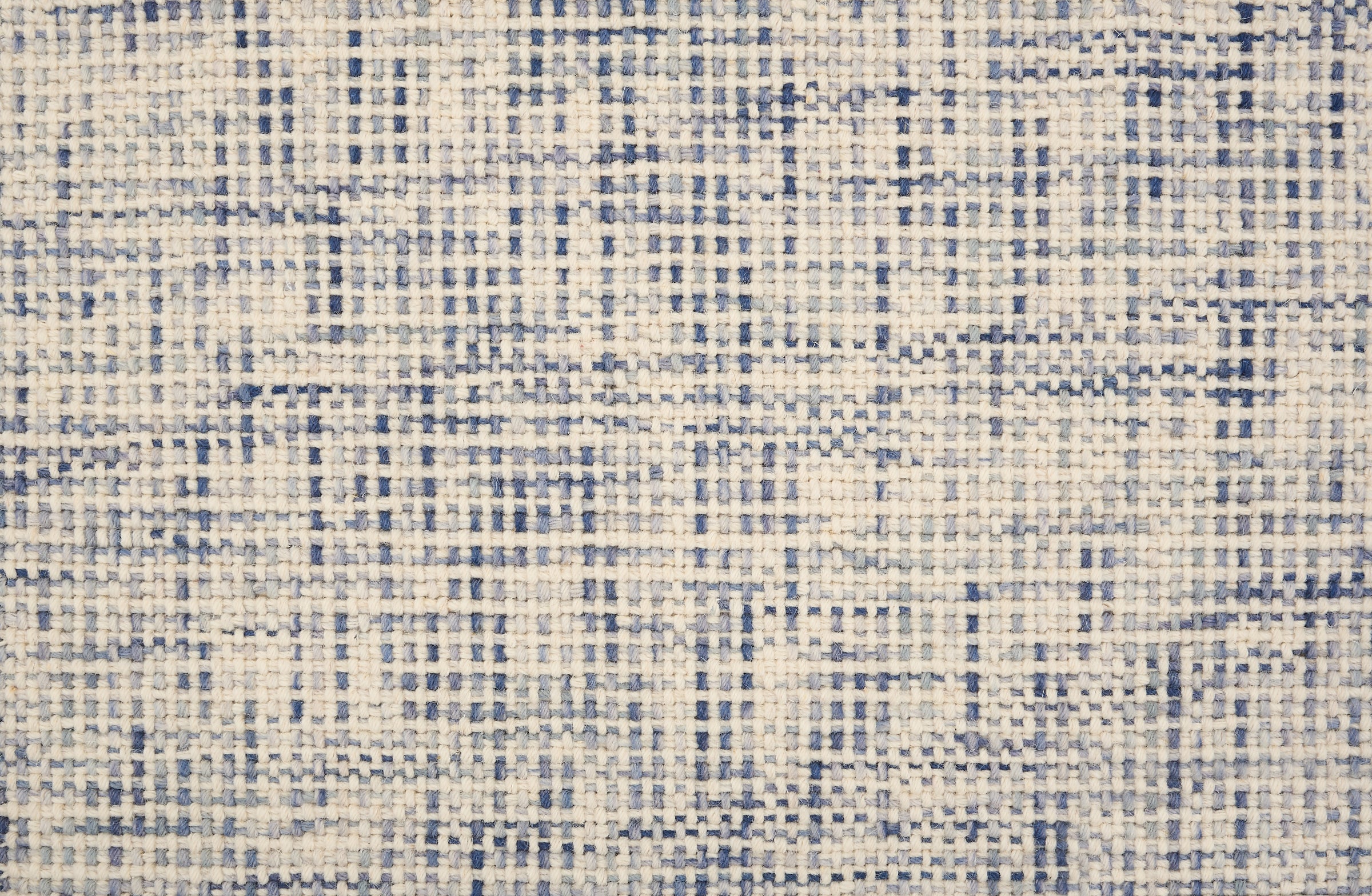 Broadloom carpet in a textural basket weave in cream mixed with shades of blue.