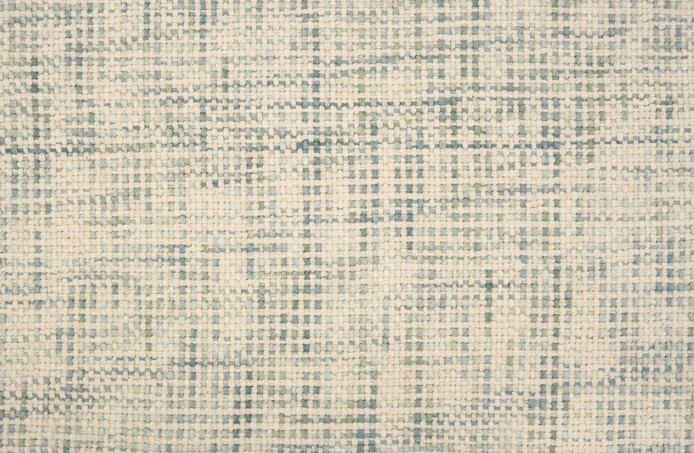 Broadloom carpet in a textural basket weave in cream mixed with blue and green.