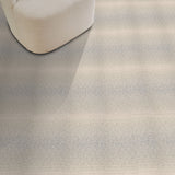 Textured gray carpet with a chair and red pillow in the corner