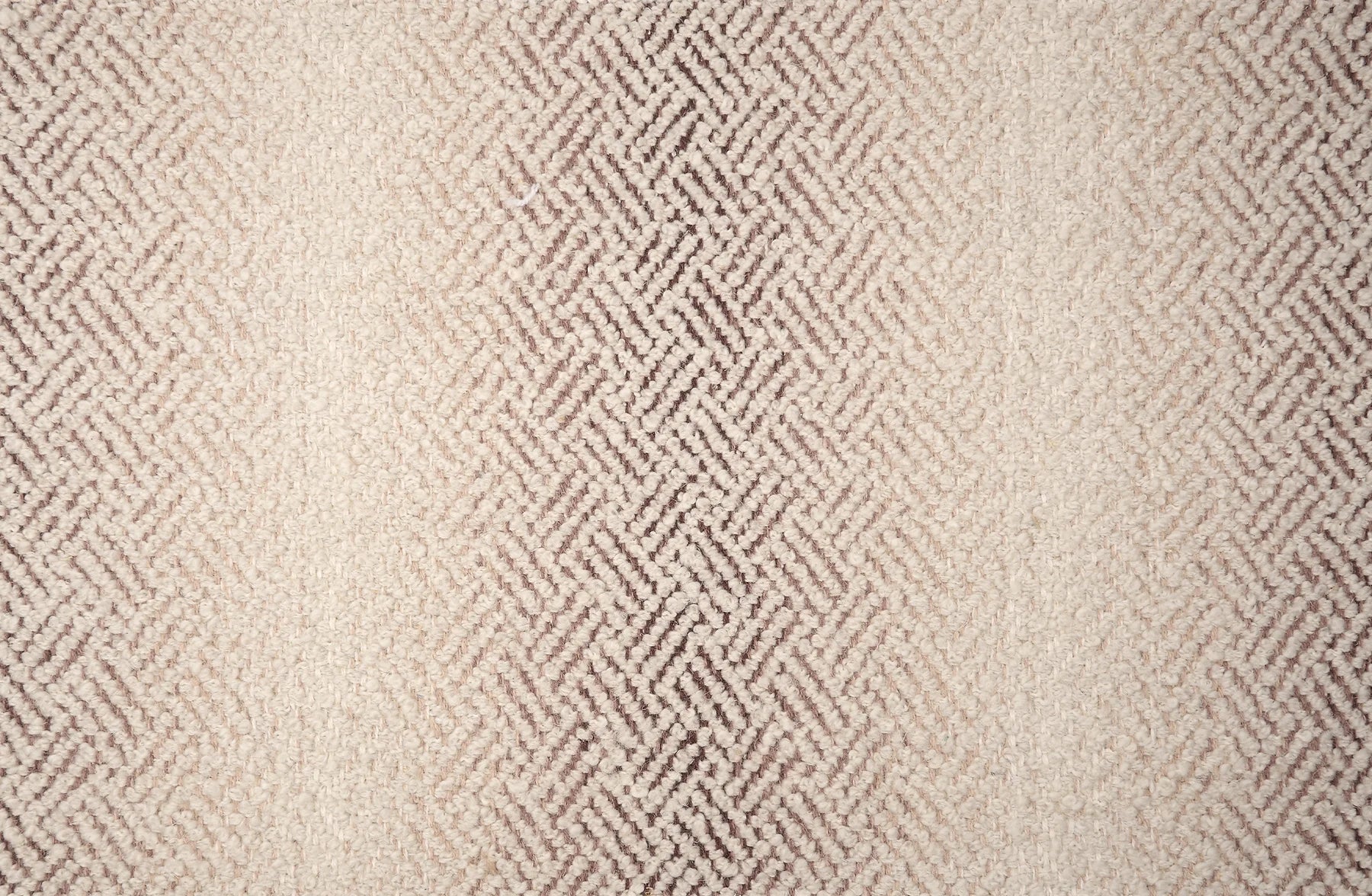 Broadloom with a geometric pattern on an ombré background in cream and taupe.