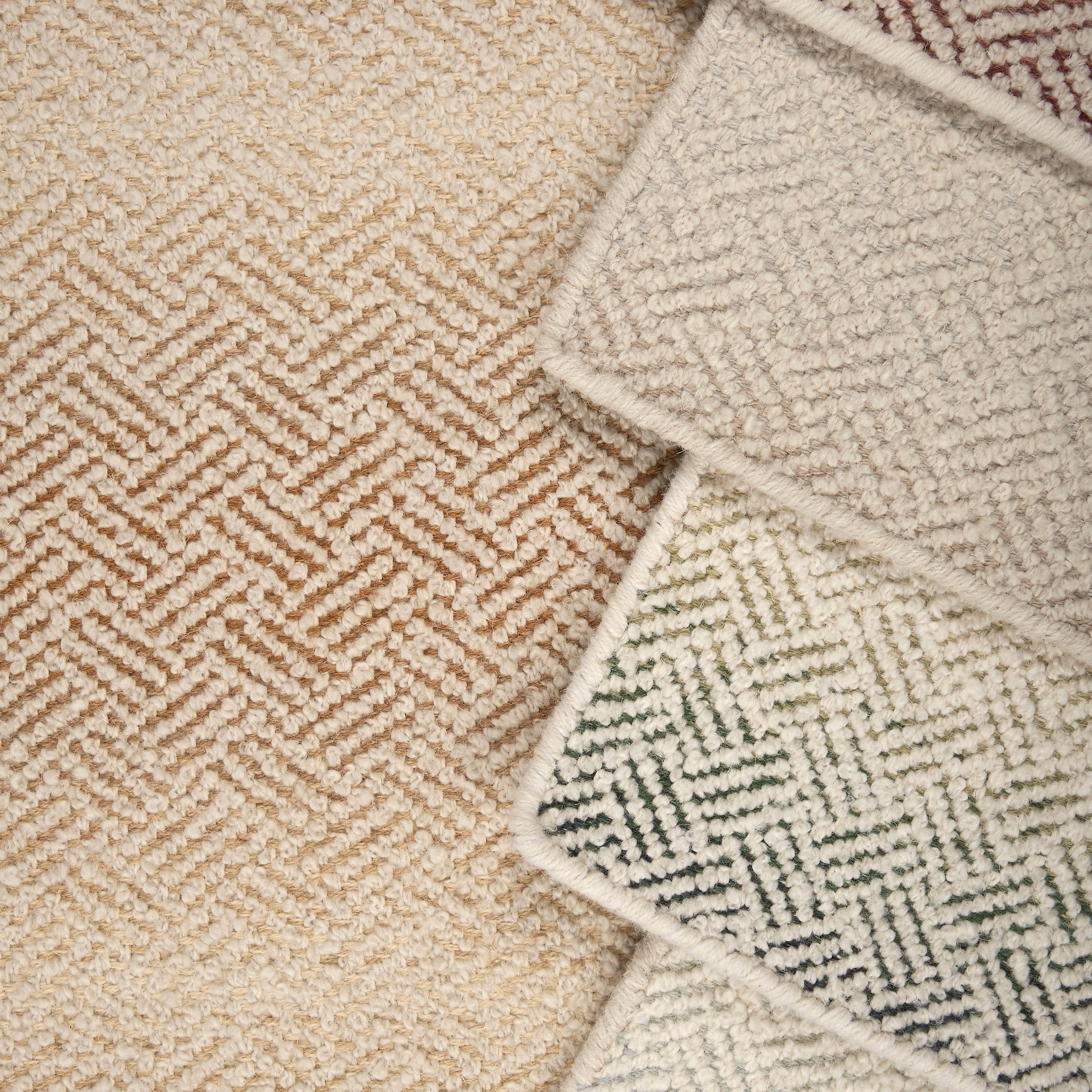 Close-up of textured carpet swatches with geometric pattern
