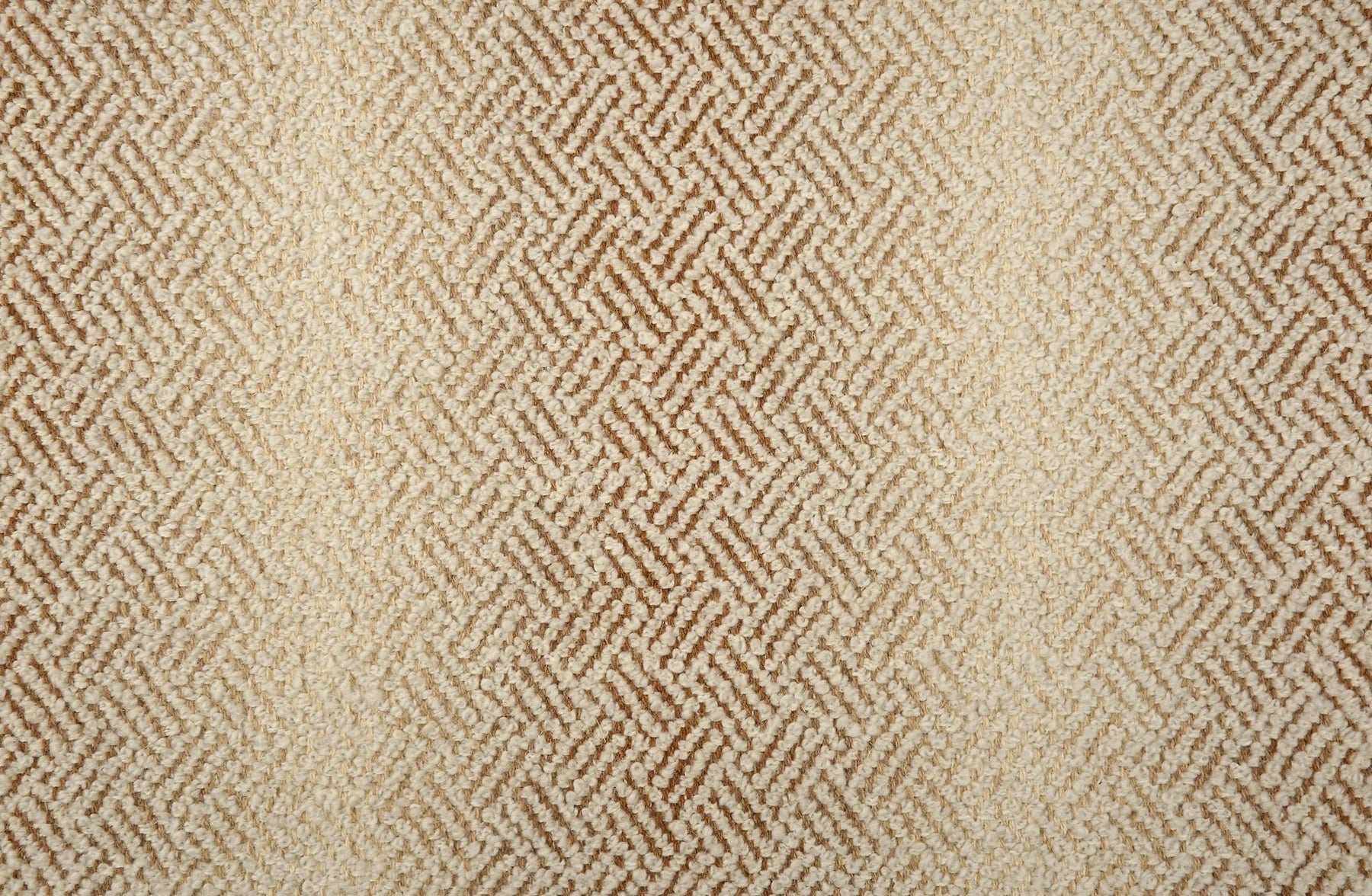 Broadloom with a geometric pattern on an ombré background in beige and tan.