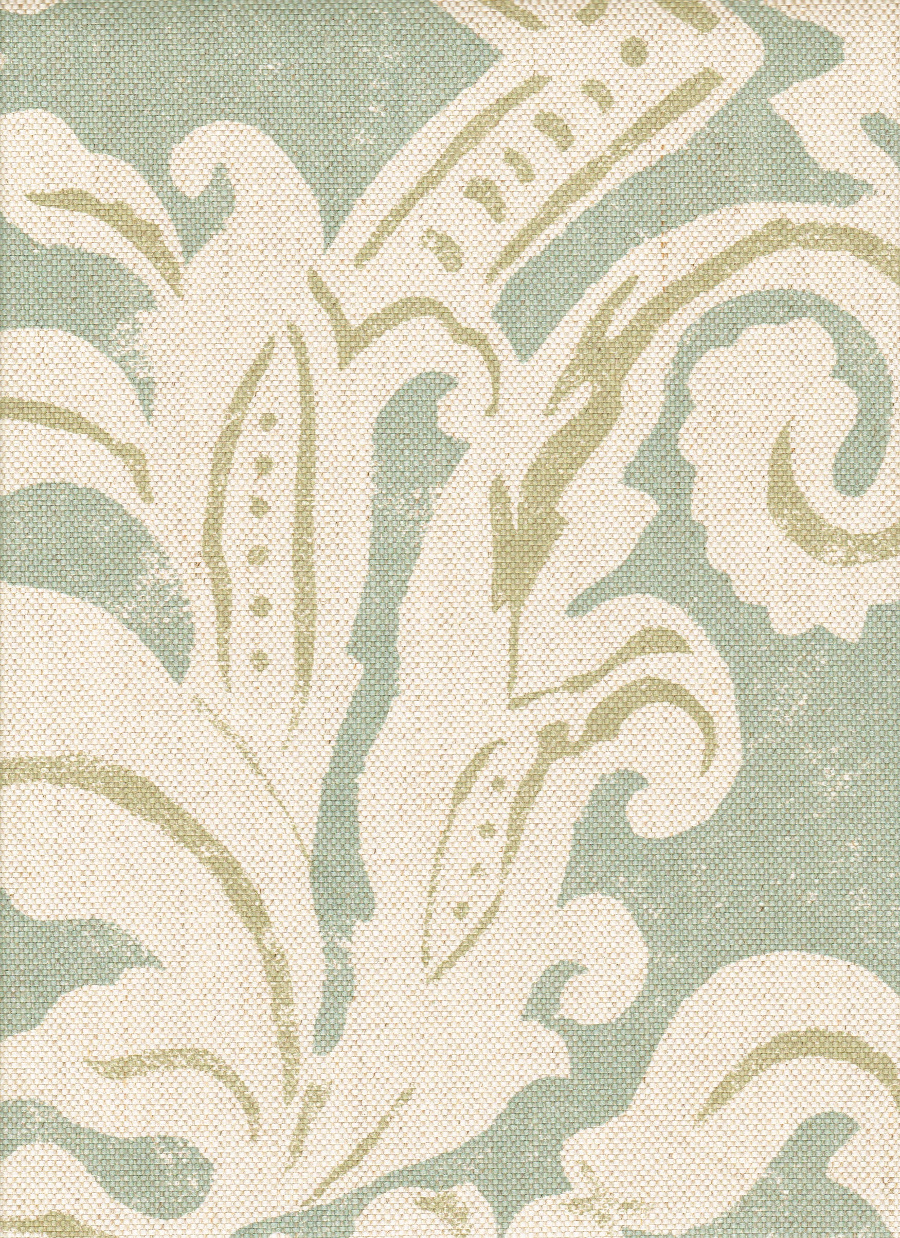 Detail of fabric in a floral damask print in cream and light green on a turquoise field.