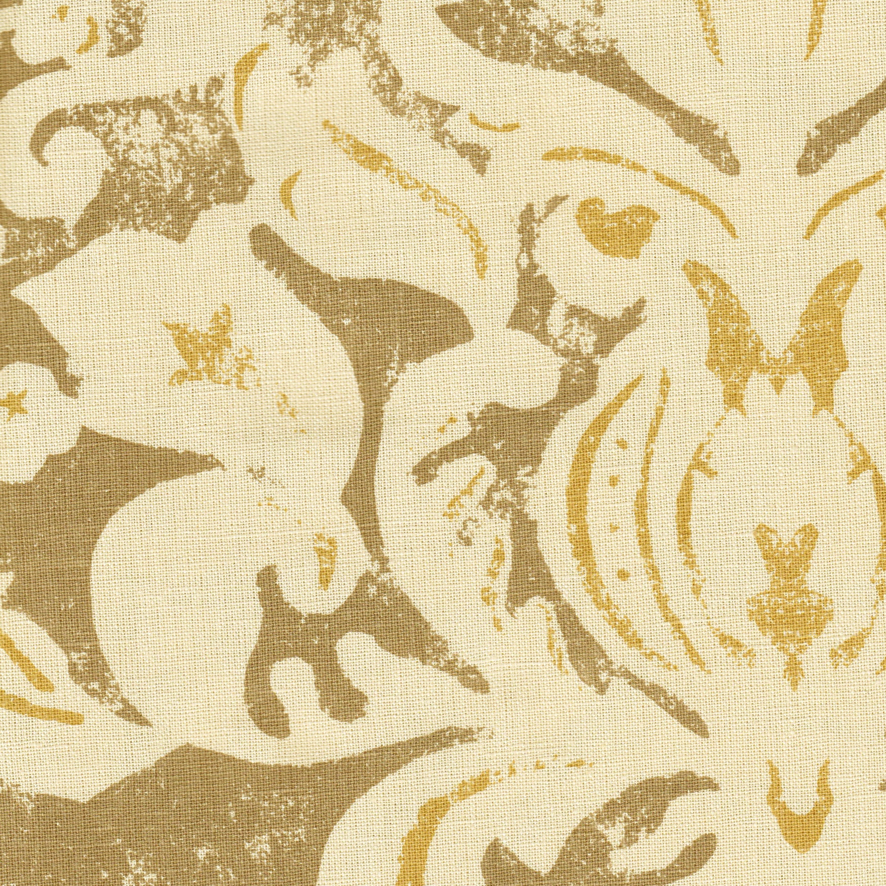 Detail of fabric in a floral damask print in white and yellow on a brown field.