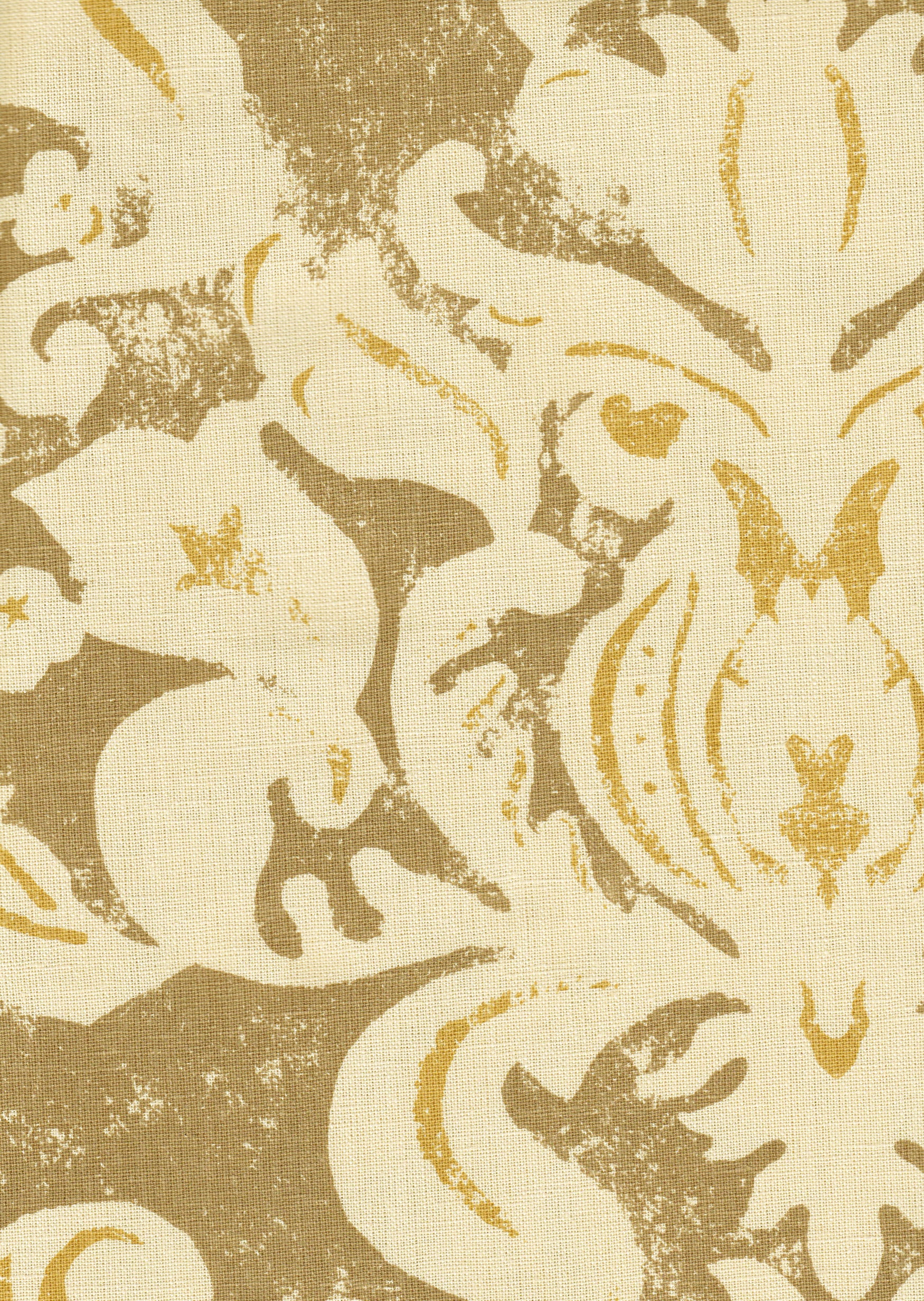 Detail of fabric in a floral damask print in white and yellow on a brown field.