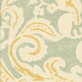 Detail of fabric in a floral damask print in white and yellow on a light blue field.