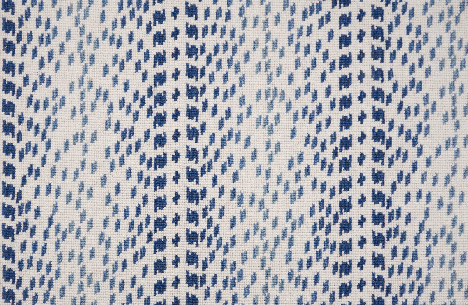 Broadloom carpet with a dashed stripe in shades of blue on a cream field. 