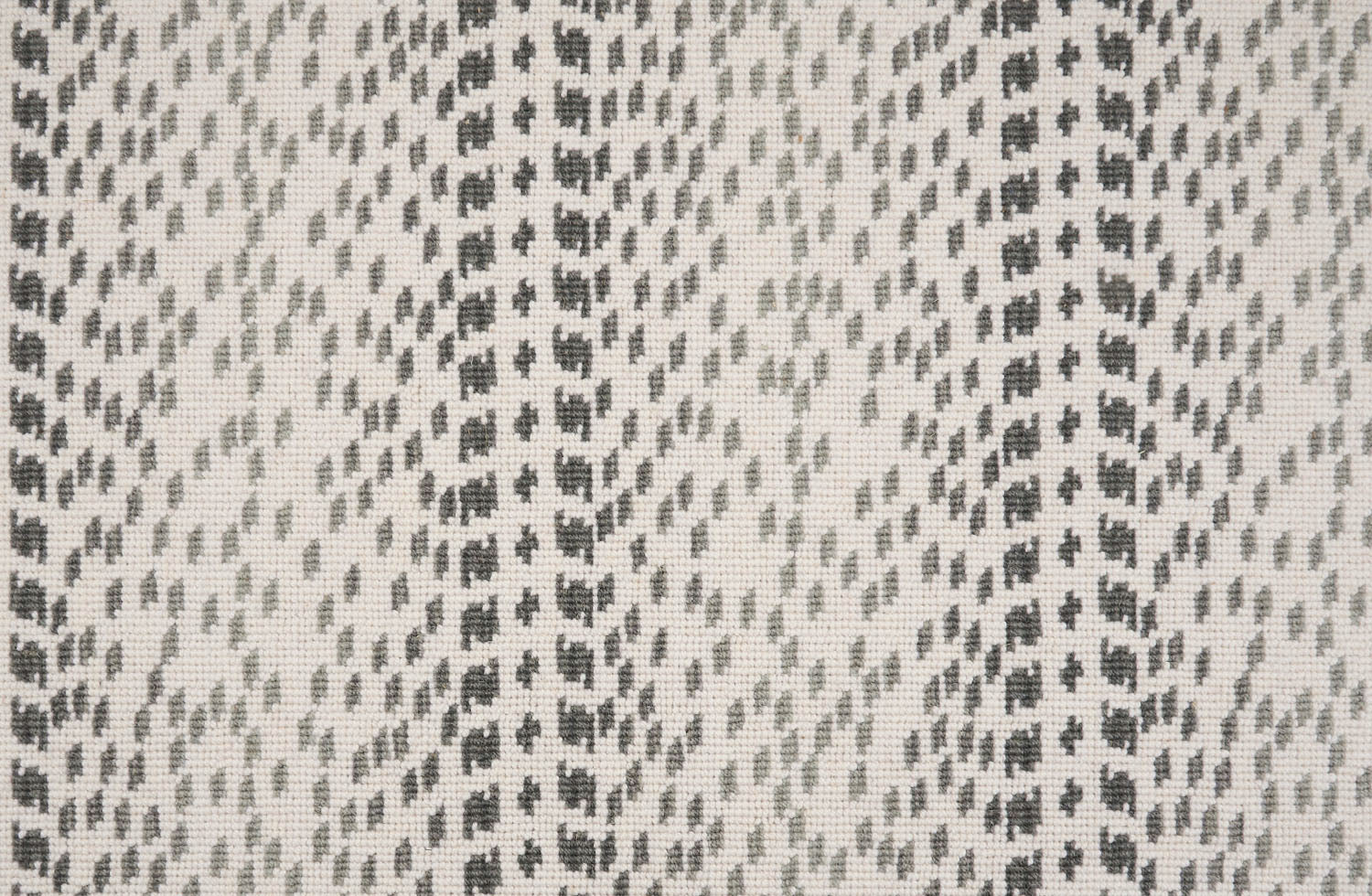 Broadloom carpet with a dashed stripe in shades of grey on a cream field. 