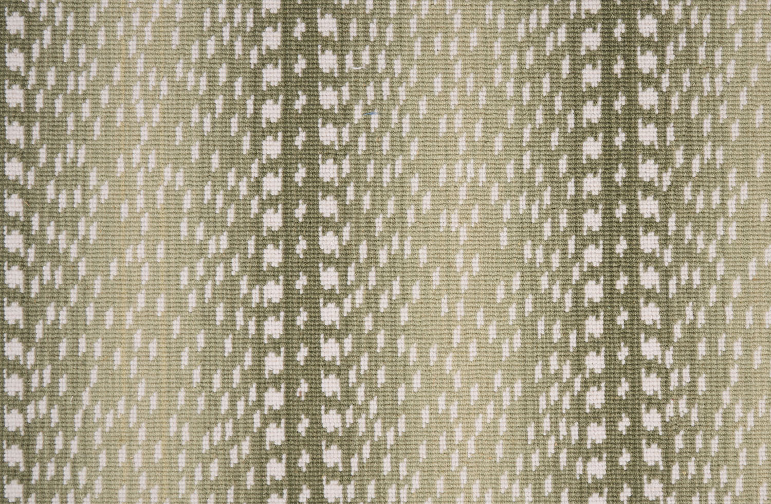 Broadloom carpet with a cream dashed stripe on an ombré field in shades of green.
