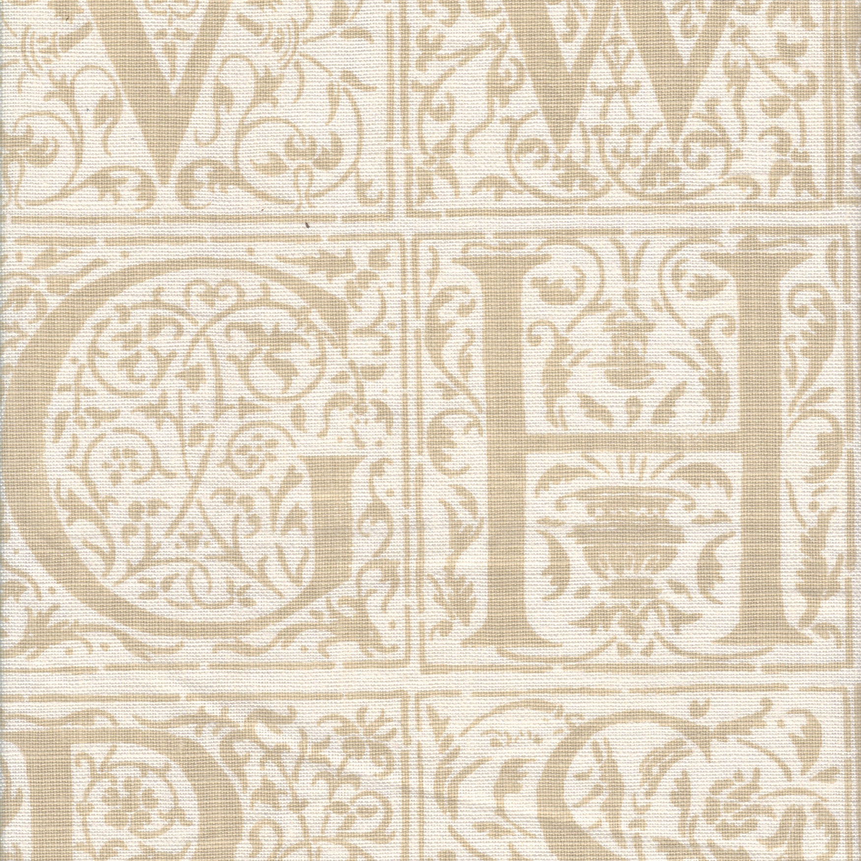 Detail of fabric in a playful alphabet grid print in tan on a cream field.