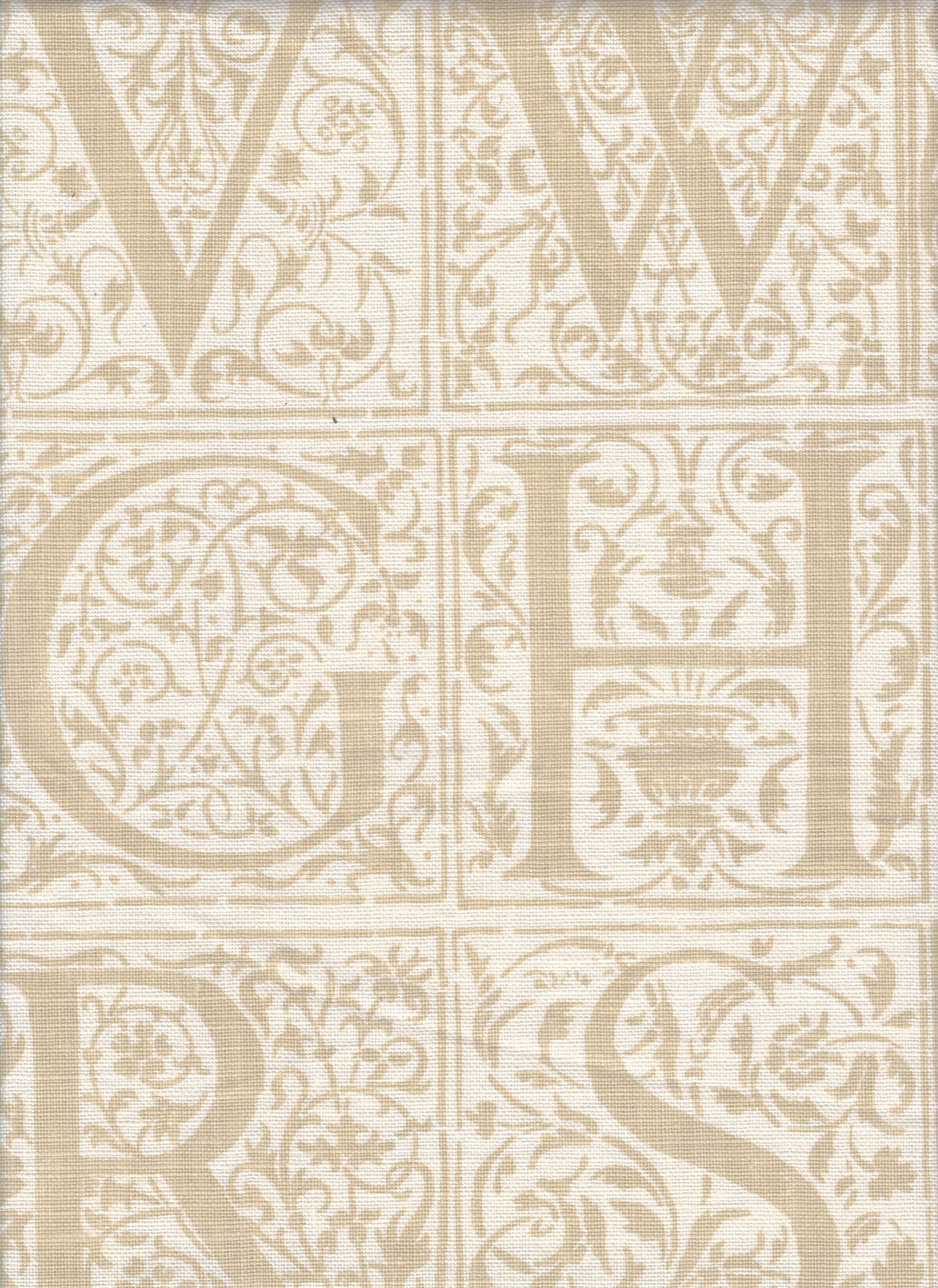 Detail of fabric in a playful alphabet grid print in tan on a cream field.