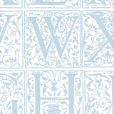 Detail of wallpaper in a playful alphabet grid print in light blue on a white field.