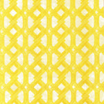 Detail of fabric in an intricate lattice print in yellow on a cream field.