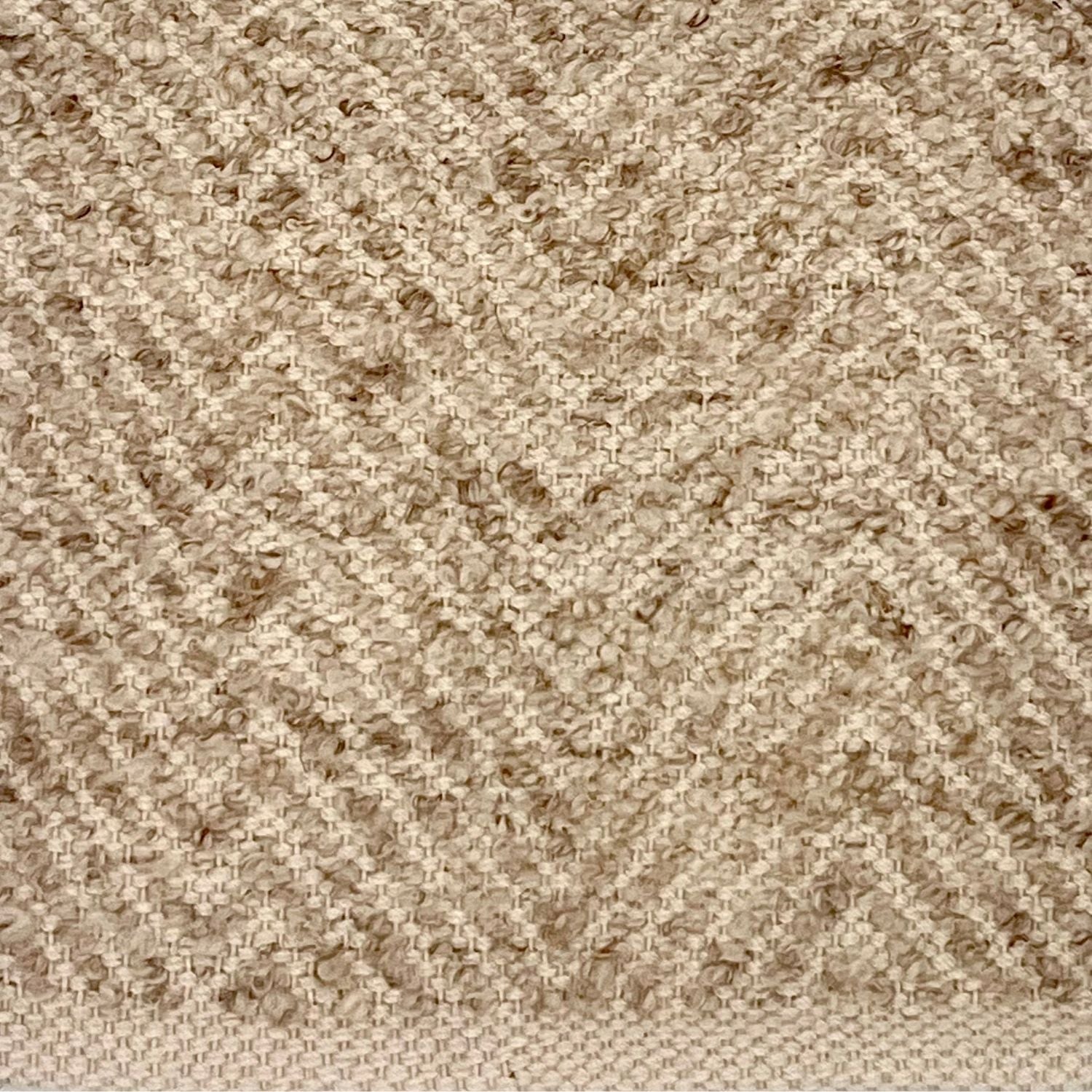 Detail of a flatwoven rug in taupe with a textural chevron pattern