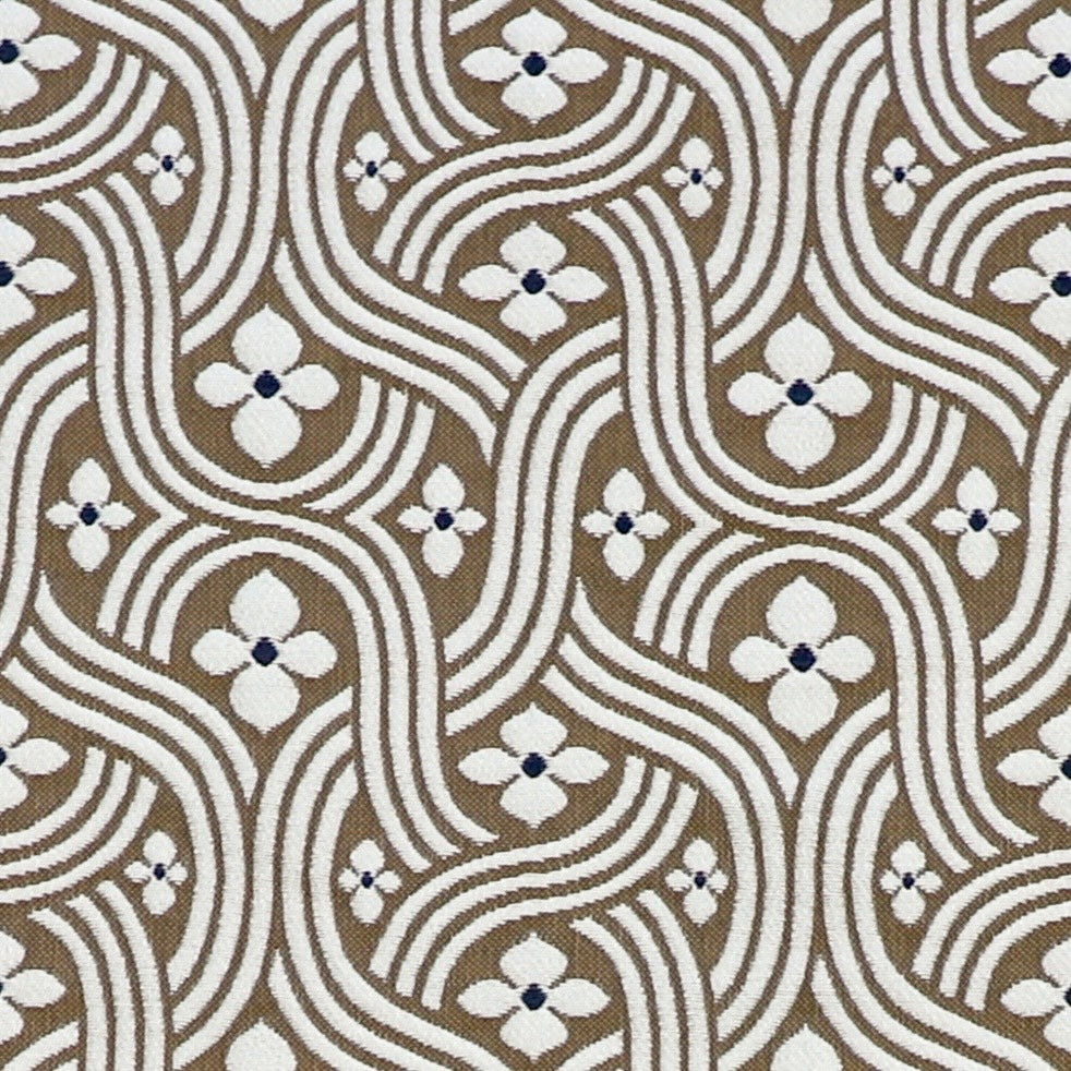 Detail of fabric in a floral damask print in white and black on a brown field.