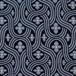 Detail of fabric in a floral damask print in blue and white on a black field.