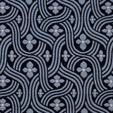 Detail of fabric in a floral damask print in blue and white on a black field.